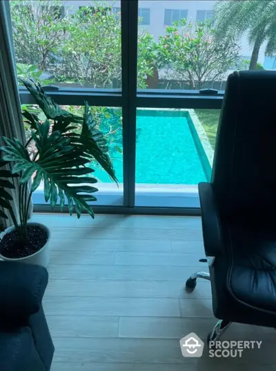 Luxurious office view with poolside tranquility and lush greenery