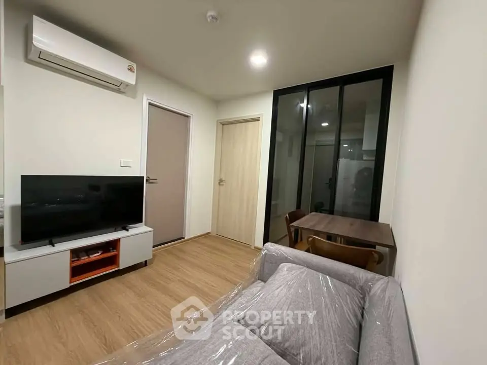 Modern living room with sleek furniture and air conditioning in a cozy apartment.