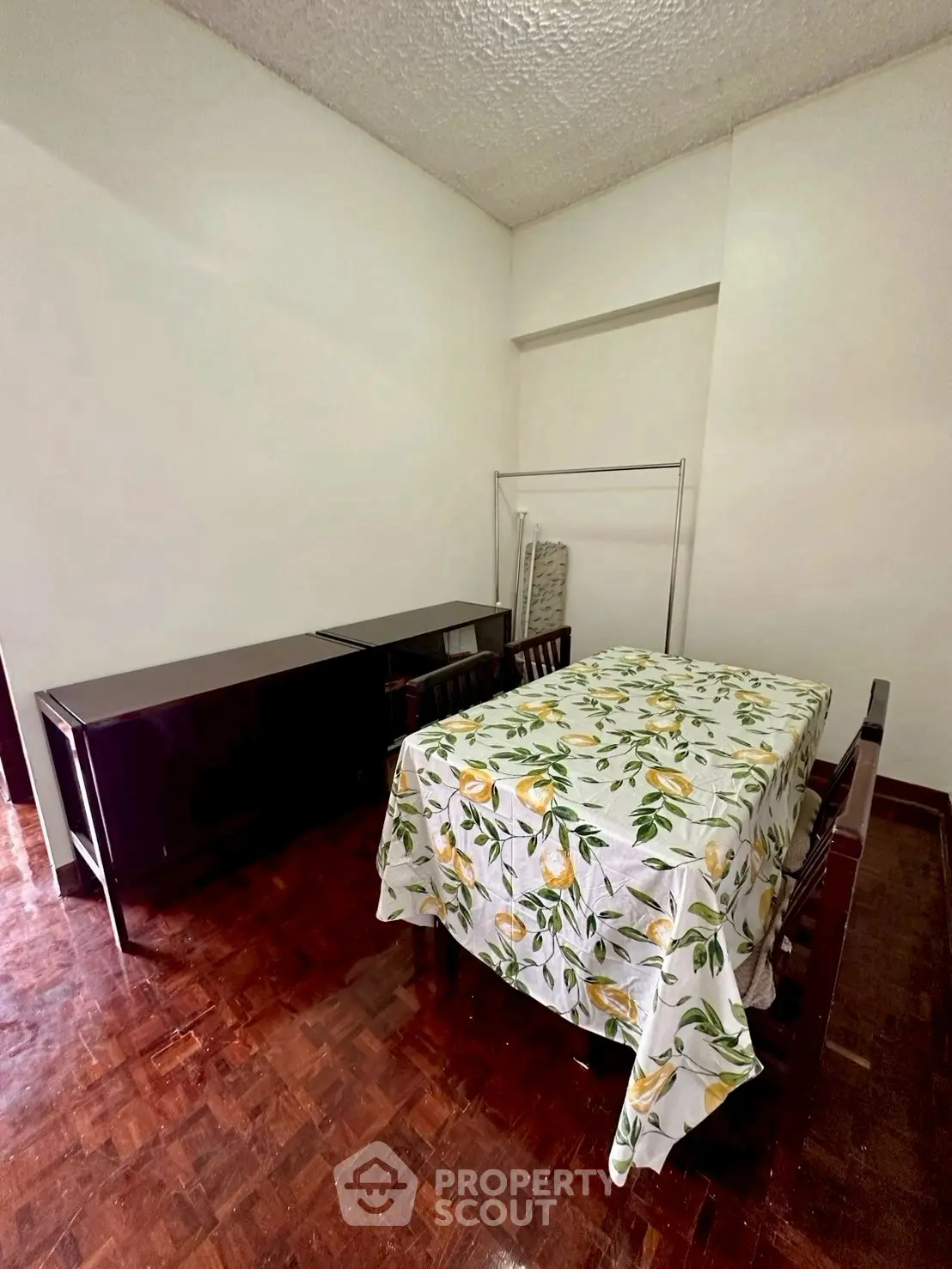 Cozy dining area with floral tablecloth and wooden flooring, perfect for intimate gatherings.