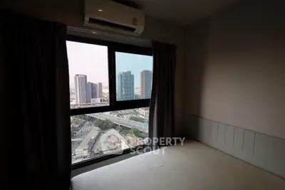 Cozy bedroom with city view from large window in modern apartment