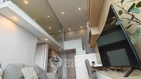 Modern loft apartment with high ceilings and stylish interior design, featuring a cozy living area and sleek kitchen.