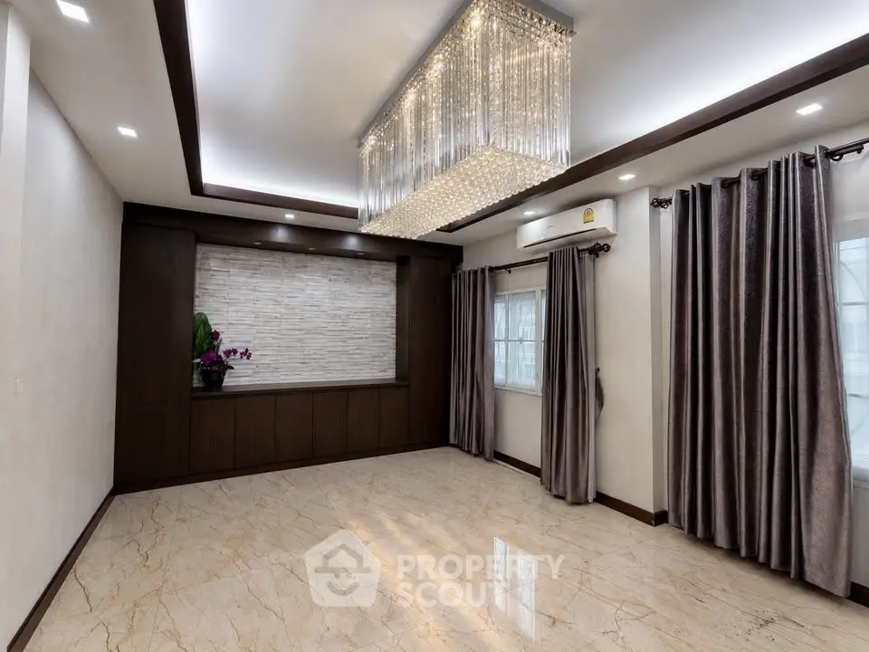 Luxurious living room with elegant chandelier and marble flooring