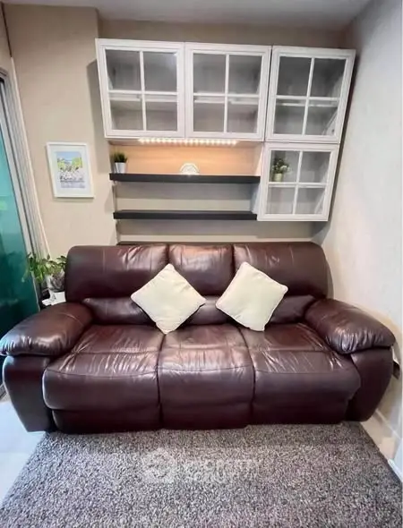 Cozy living room with leather sofa and stylish shelving