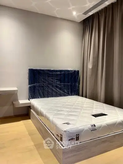 Modern bedroom with new mattress and stylish headboard in a contemporary apartment.