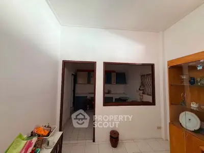 Cozy interior space with open kitchen layout and decorative shelving, perfect for modern living.