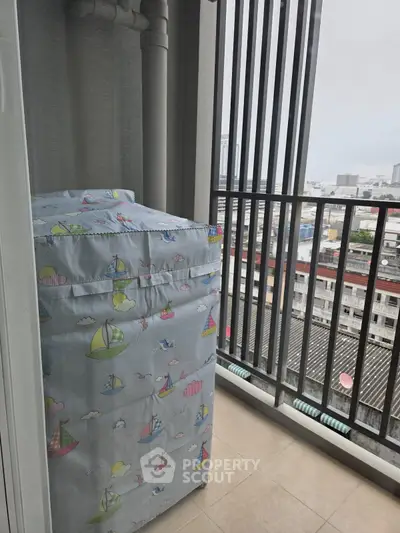 Charming balcony with city view and covered washing machine, perfect for urban living.