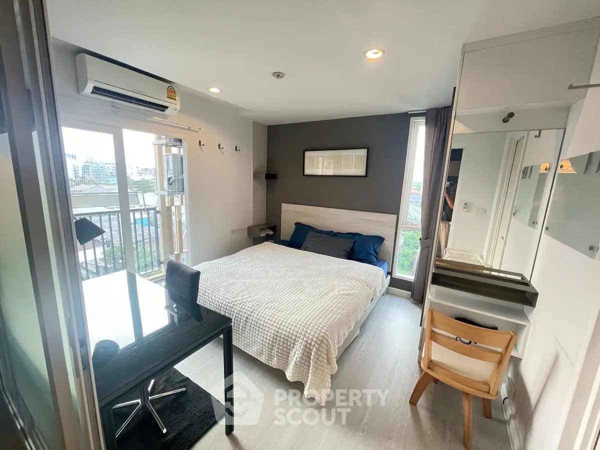 Modern bedroom with balcony view and stylish decor in urban apartment