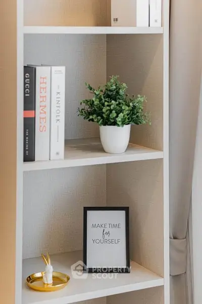 Stylish bookshelf with decor items in modern living room interior.