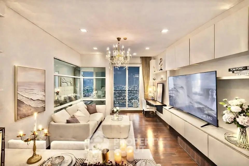 Luxurious living room with city view, elegant chandelier, and modern decor