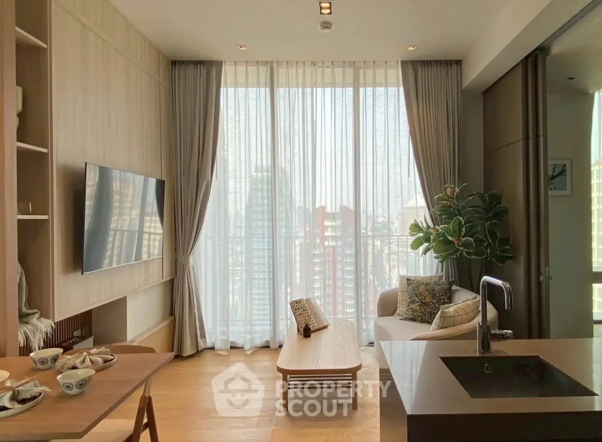 Modern living room with large windows and city view, featuring stylish decor and open layout.