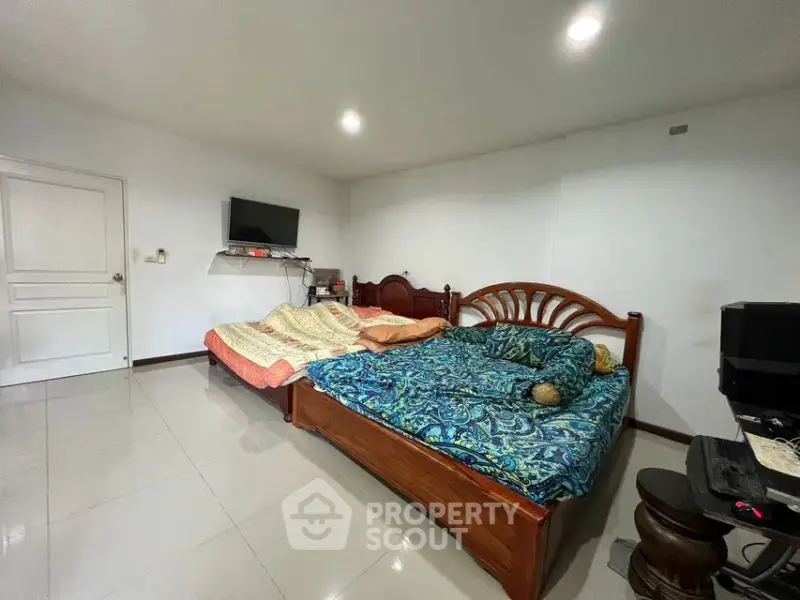Spacious bedroom with two beds and modern amenities, perfect for comfort and relaxation.