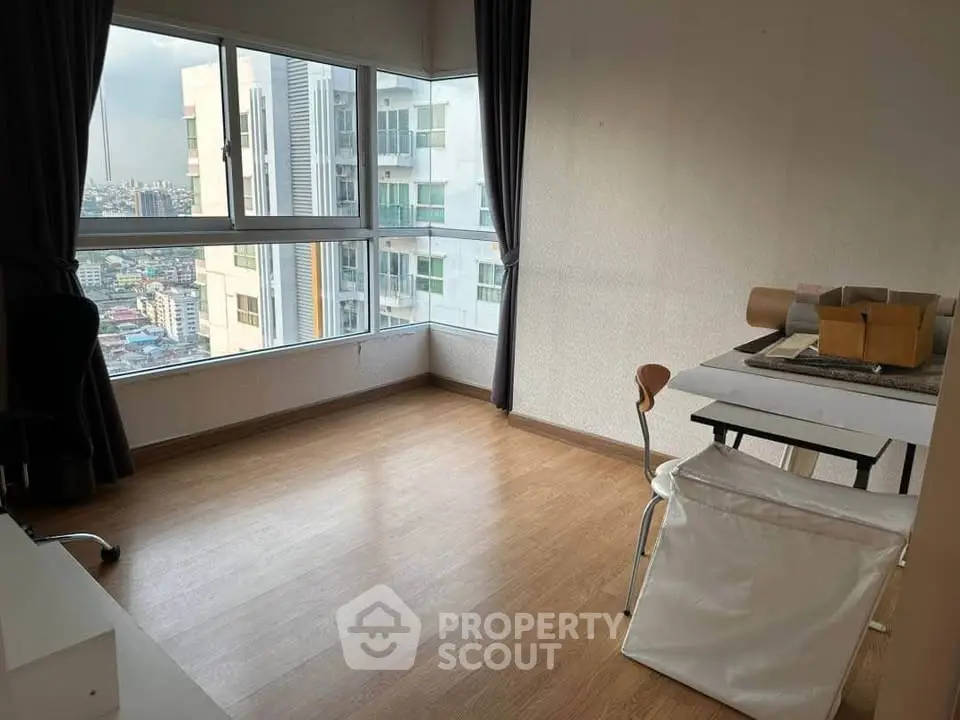 Spacious corner unit with panoramic city views and modern furnishings, perfect for urban living.