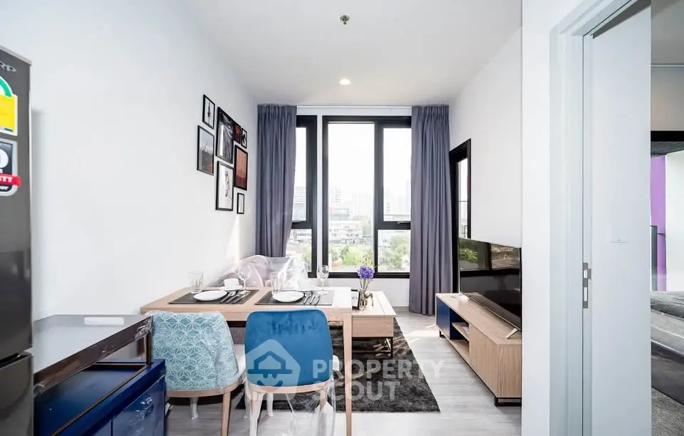 Modern living room with stylish decor and large windows offering city views