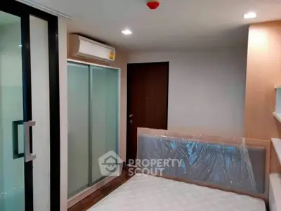Modern bedroom with sliding glass closet doors and air conditioning unit