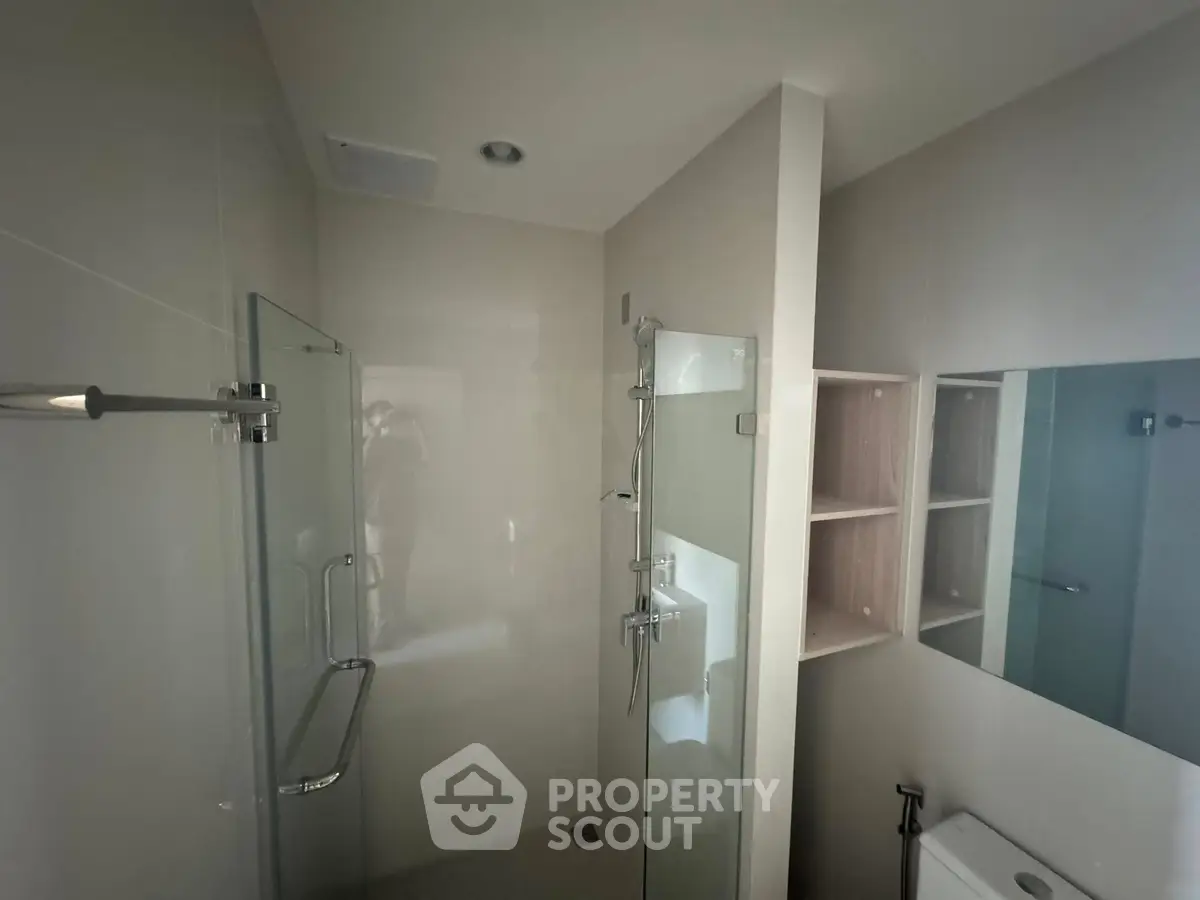 Modern bathroom with glass shower and sleek fixtures, ideal for contemporary living.