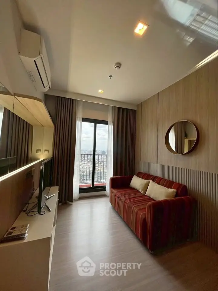 Modern living room with stylish decor and city view from large window.