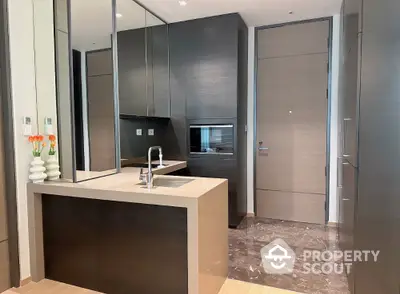 Modern kitchen with sleek cabinetry and built-in appliances in luxury apartment