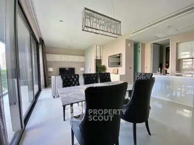 Luxurious modern living room with elegant dining area and large windows offering natural light.