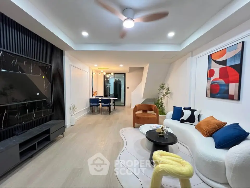 Modern living room with stylish decor, open layout, and contemporary furniture.