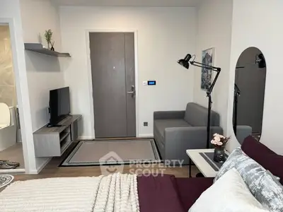 Modern studio apartment with cozy living area and stylish decor.