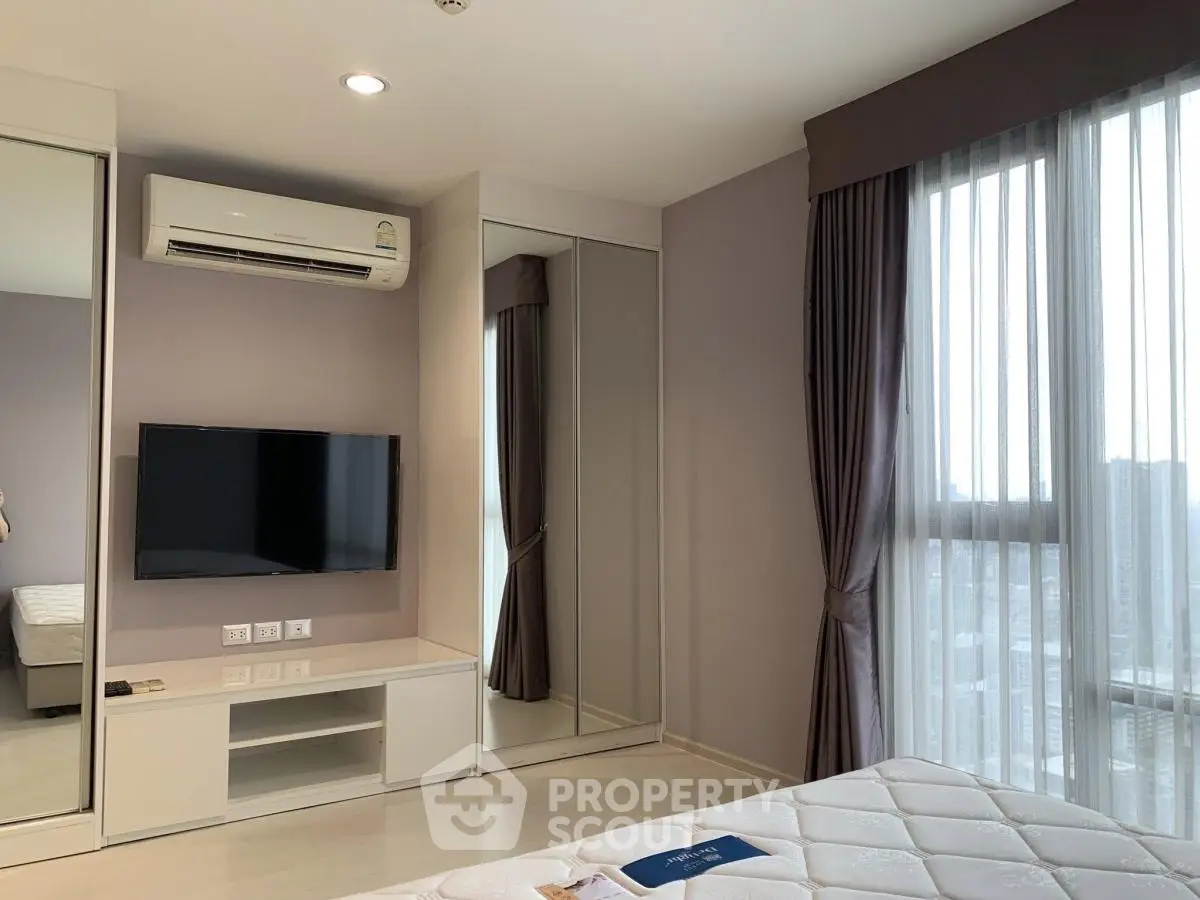 Modern bedroom with large windows, mirrored closet, and air conditioning in a stylish apartment.