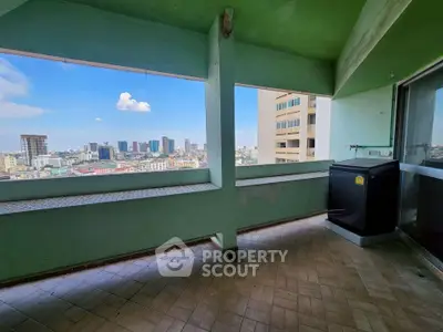 Spacious balcony with stunning city skyline view, perfect for relaxation and entertainment.