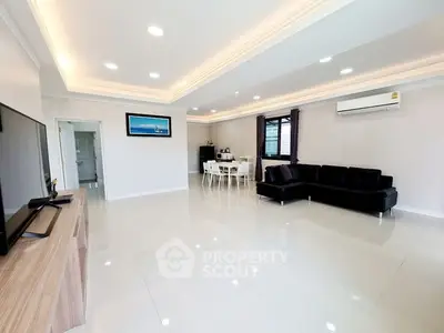 Spacious modern living room with sleek design and ample natural light