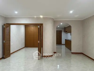 Spacious open-plan living area with elegant wooden accents and modern lighting.