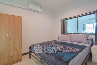 Cozy bedroom with modern decor and air conditioning in a stylish apartment.