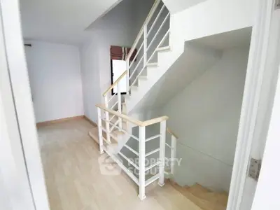 Modern staircase with sleek railing in a bright, minimalist home interior