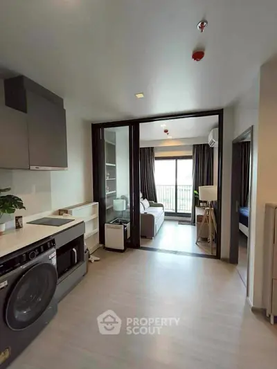 Modern apartment interior with washing machine and open living area