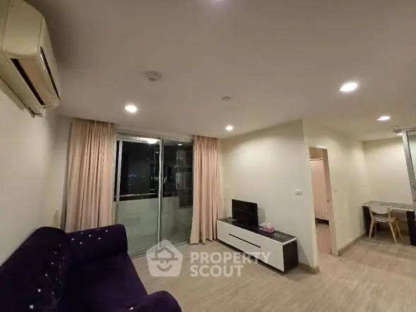 Modern living room with balcony access and sleek furniture