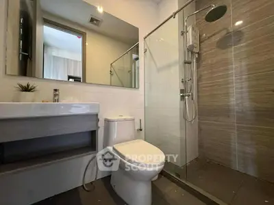 Modern bathroom with glass shower and sleek fixtures
