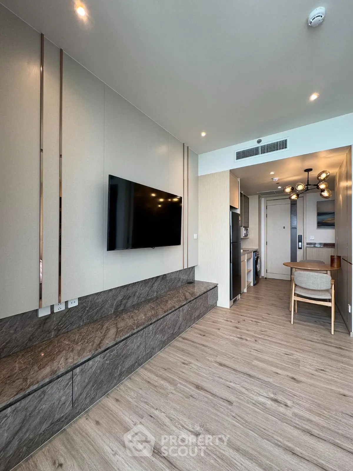 Modern living room with sleek design and open kitchen layout in luxury apartment