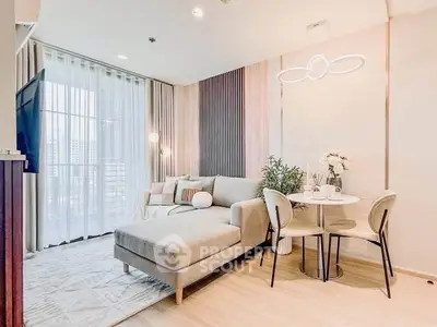 Modern living room with stylish decor and natural light, featuring a cozy sofa and dining area.