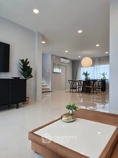 Spacious modern living room with elegant dining area and stylish decor