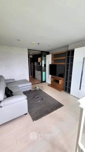 Modern living room with sleek furniture and open layout in a stylish apartment.