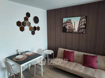 Modern living room with stylish decor, featuring a cozy sofa, dining table, and wall art in a chic apartment.