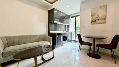 Modern living room with sleek kitchen and stylish furniture in open layout apartment.