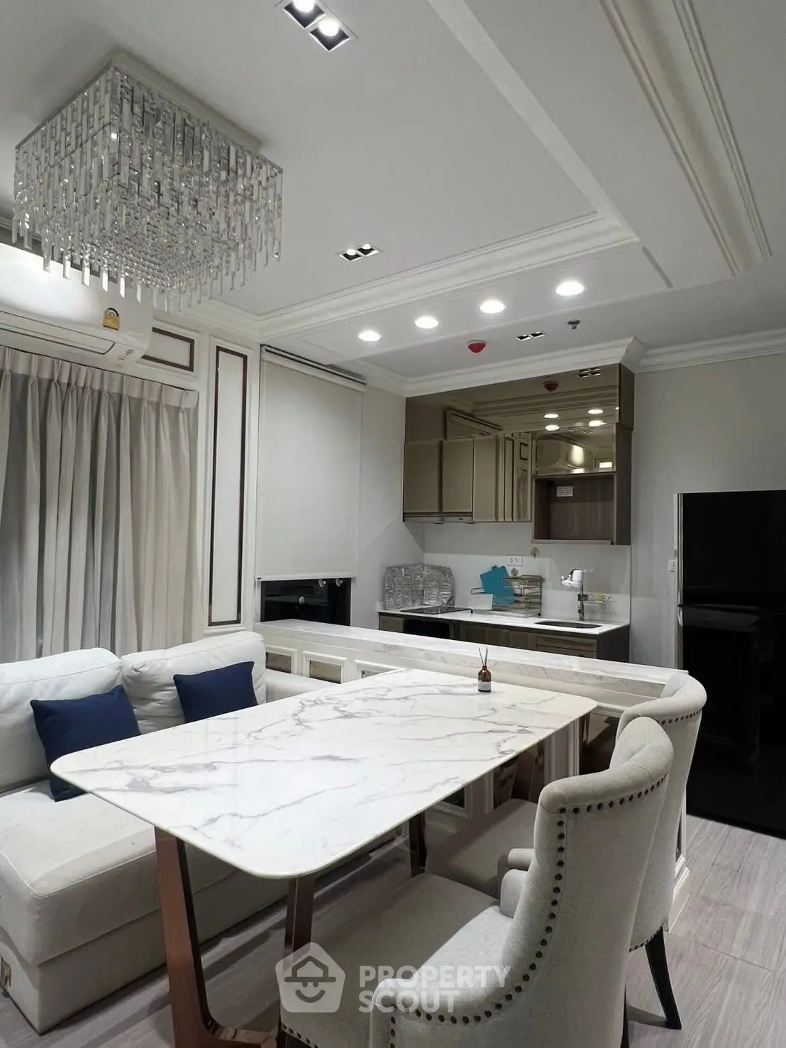 Luxurious modern living room with elegant chandelier and marble dining table