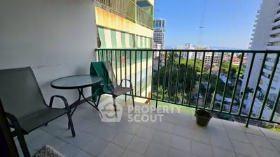 Spacious balcony with city view, perfect for relaxation and outdoor dining.