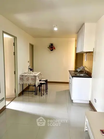Cozy apartment with compact kitchen and dining area, perfect for modern living.
