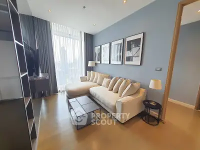 Modern living room with stylish decor and large windows offering city views.