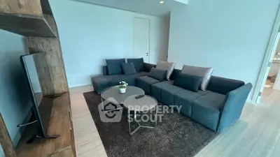 Modern living room with stylish gray sofas and sleek TV setup