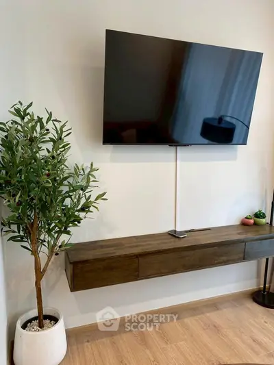 Modern living room with wall-mounted TV and stylish wooden console