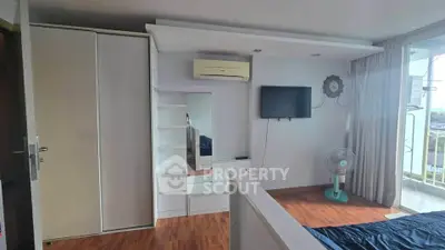 Modern bedroom with air conditioning and balcony view