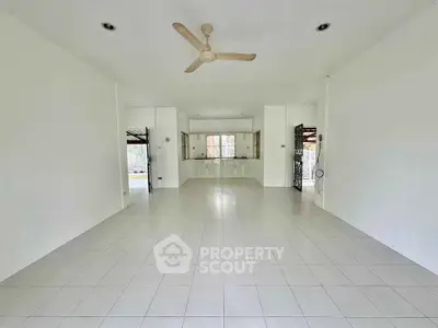 Spacious open-plan living area with tiled flooring and ceiling fan, ideal for modern living.
