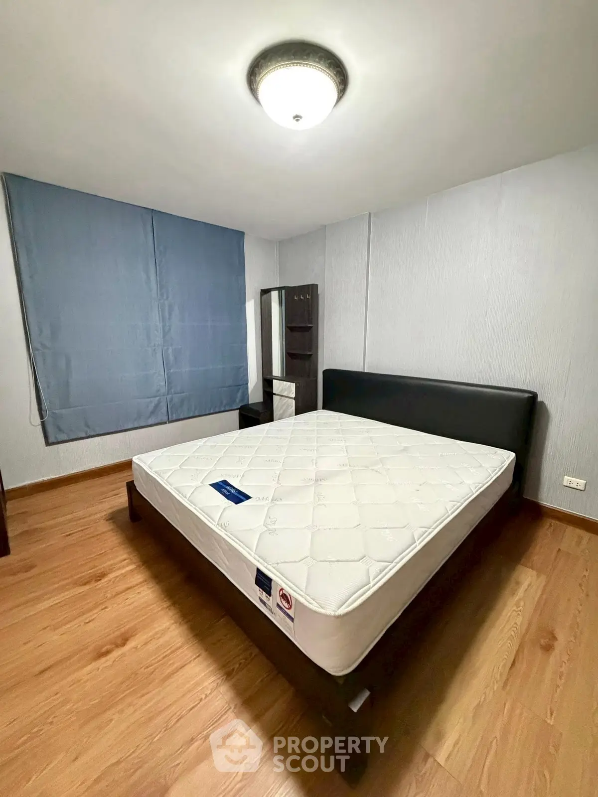 Spacious bedroom with modern design and large bed, perfect for relaxation.
