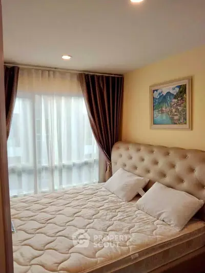 Cozy bedroom with elegant decor and large window for natural light