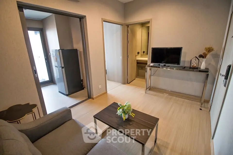 Modern living room with sleek furniture and open kitchen layout